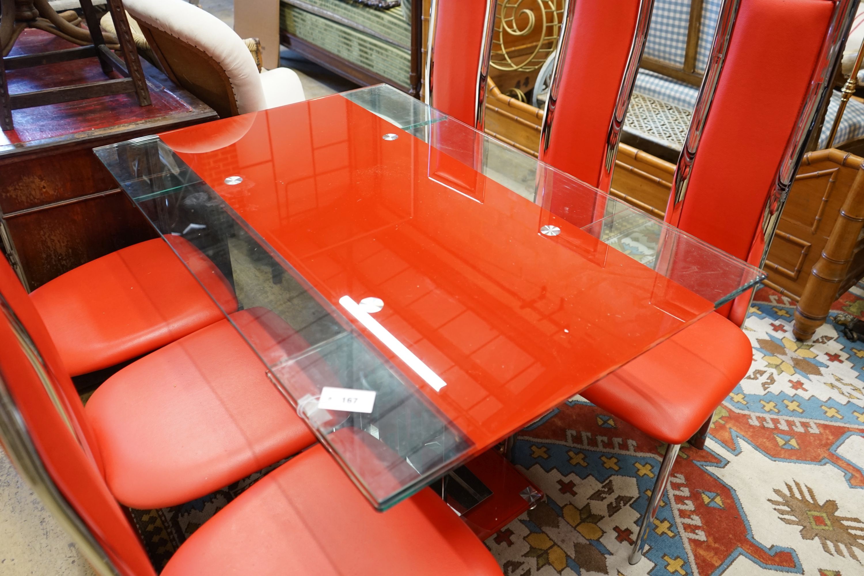 A set of red Italian design dining chairs and an associated chrome table, width unextended 120cm depth 80cm height 75cm